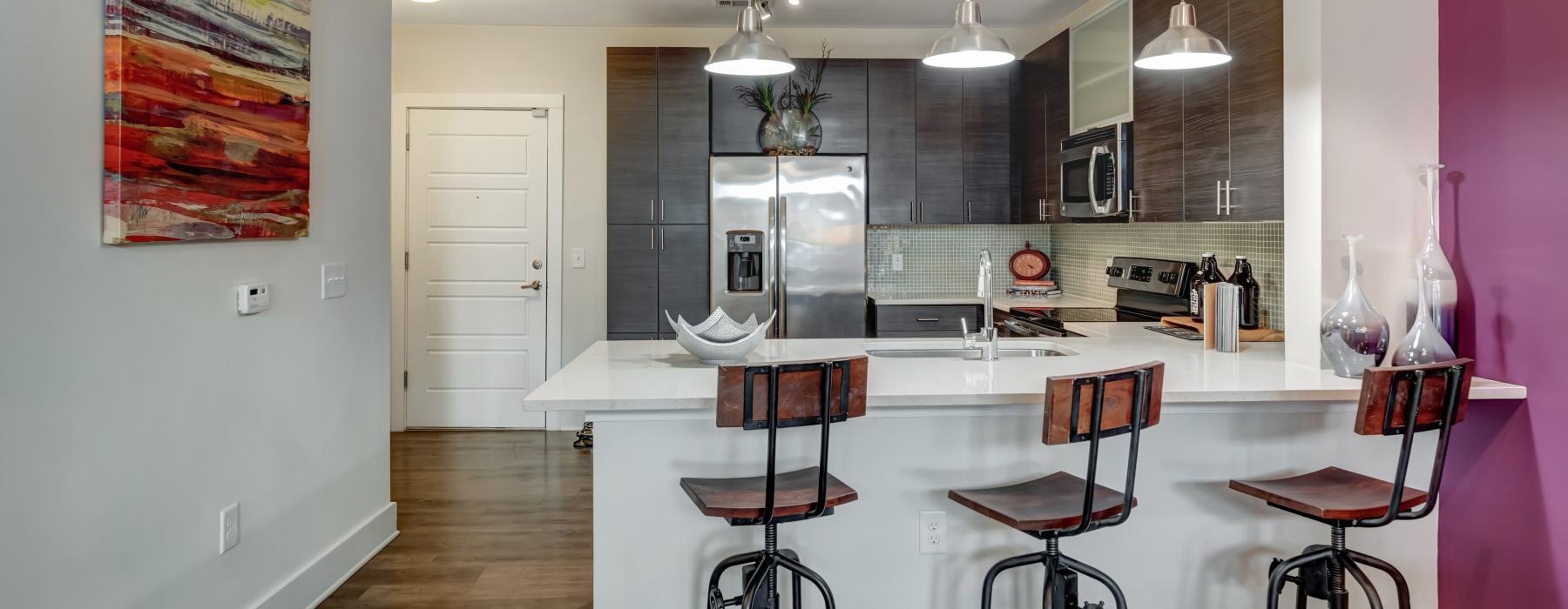 a kitchen with a bar stools