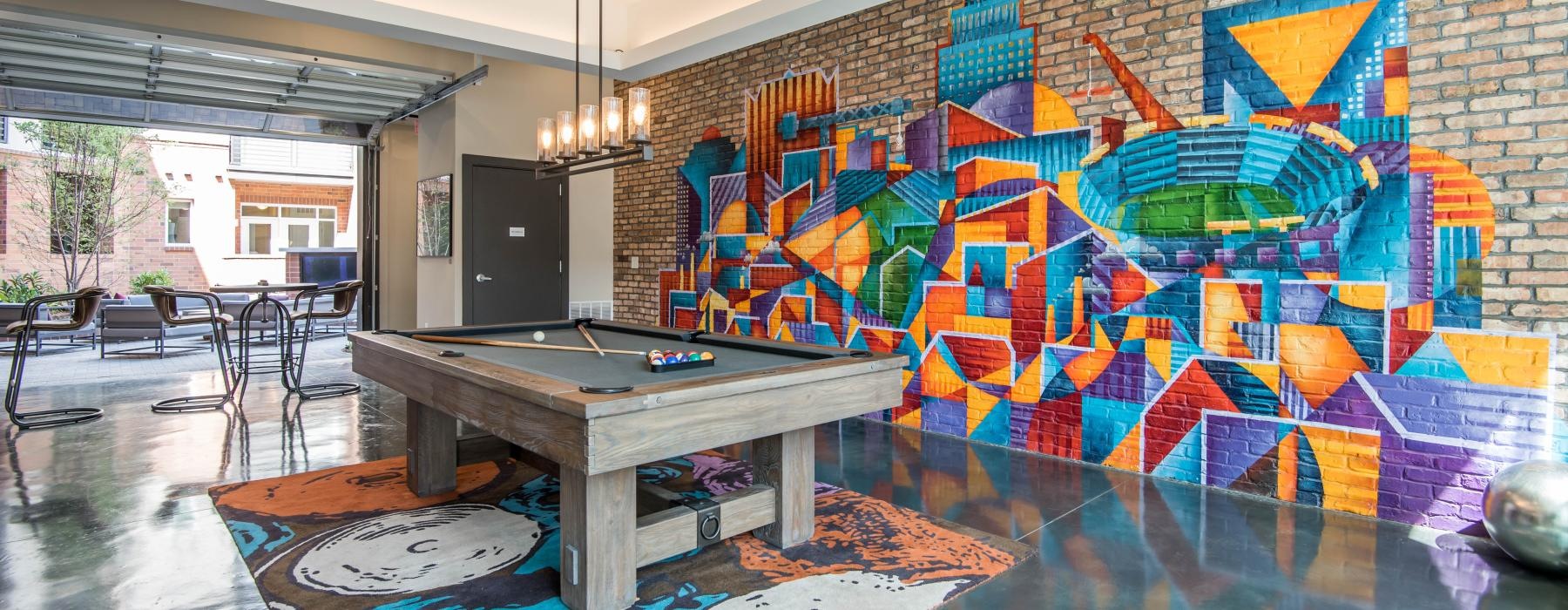 a room with a pool table and chairs