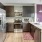 a kitchen with a pink wall