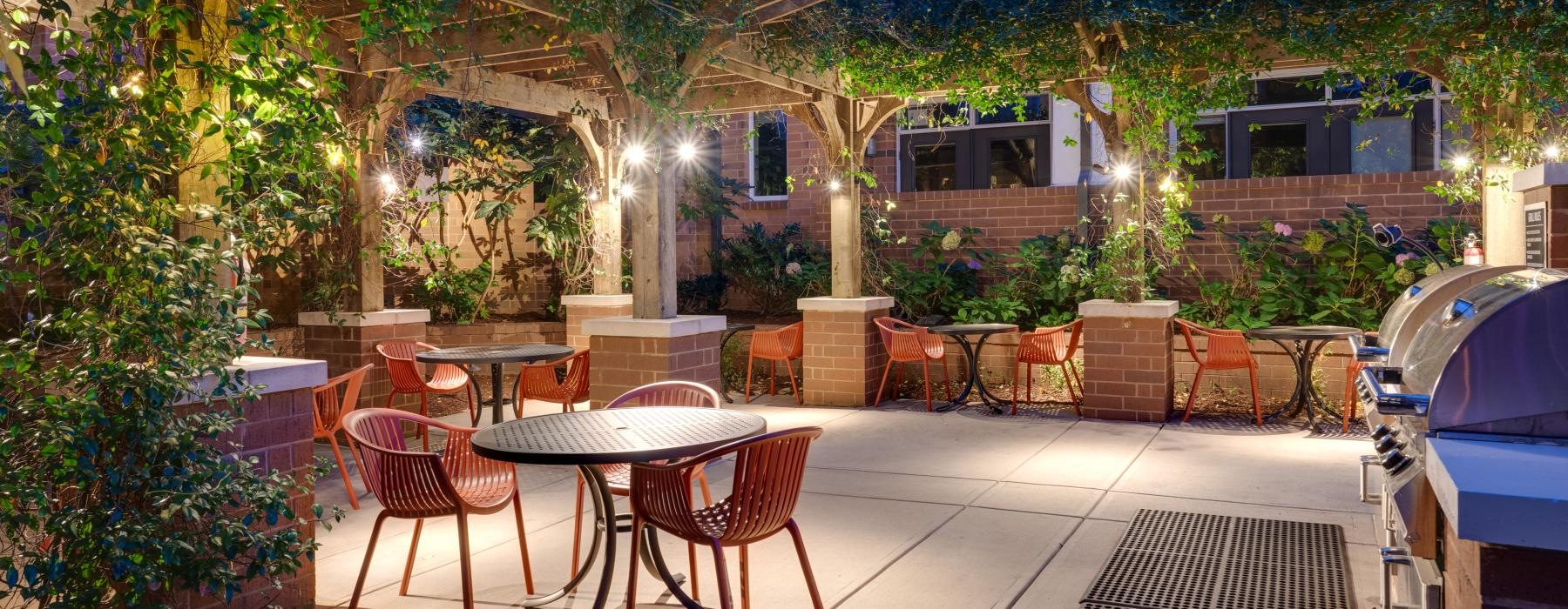 a patio with tables and chairs