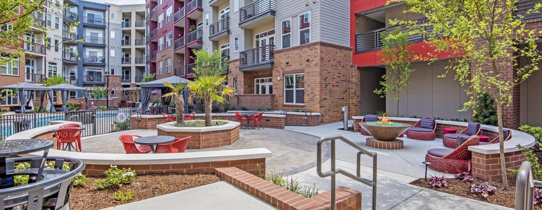 a courtyard with a fountain and buildings