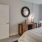 a bedroom with a mirror and a bed