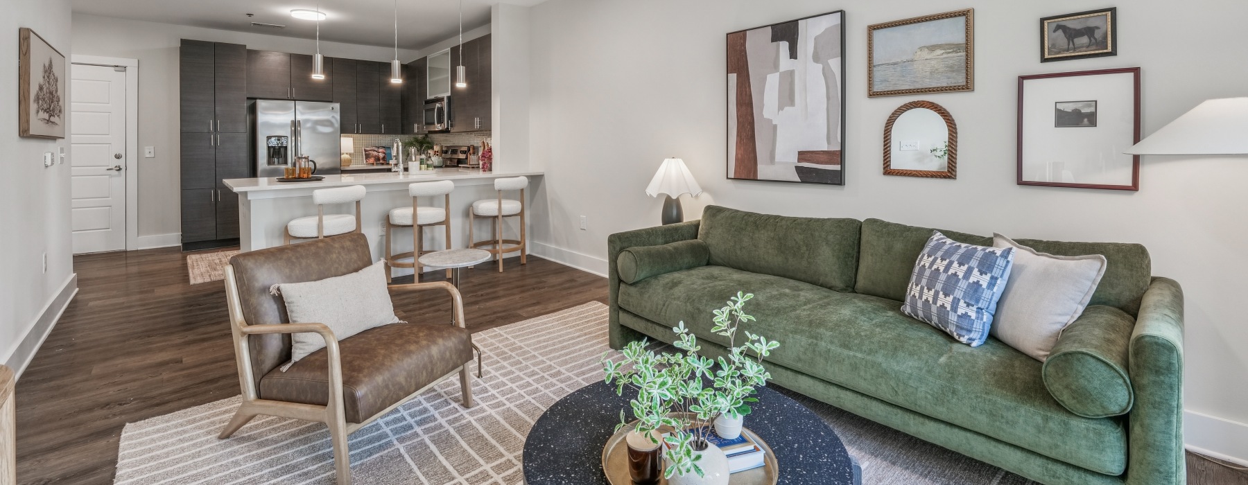 living room with couch and chair with kitchen in background